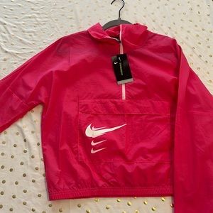 This is a pink Nike running jacket that has never been worn. Still has tags